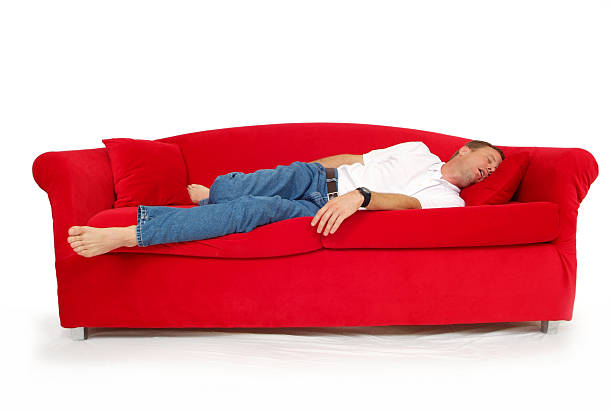 istock Man Asleep on a Red Couch with a White Background 174905790
