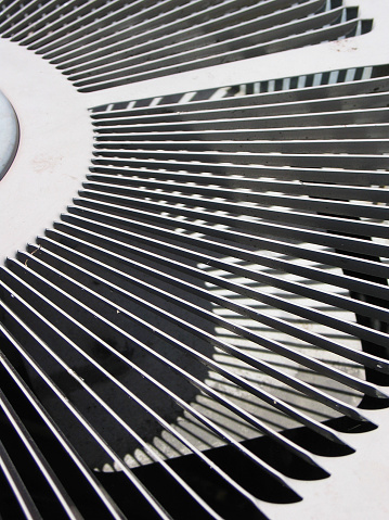 This is a fan in an air conditioning unit I found in an alley. It's stark coloring and shadows make this a great subject for high-contrast imagery and would also make a nice background.