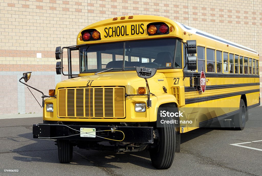 Yellow behemoth modern school busThe white material on the top is reflective to keep cooler. There is a guard on the front bumper that will extend when children cross in front. Bus Stock Photo