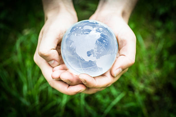 Blue globe in hands stock photo