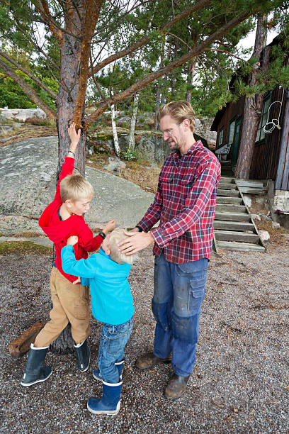 istock Father trying to quite down his fighting little boys. 174906591