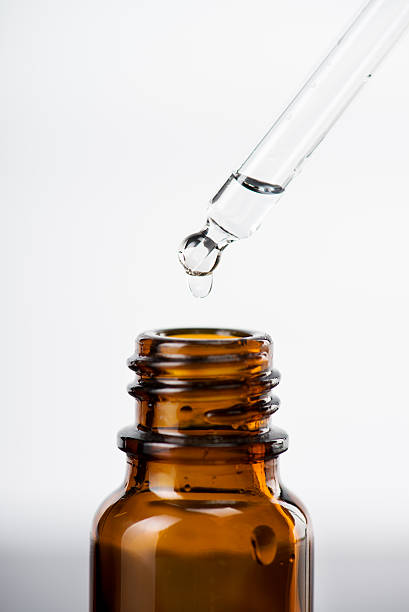 istock Liquid being dropped into a bottle from a pipette 174906749