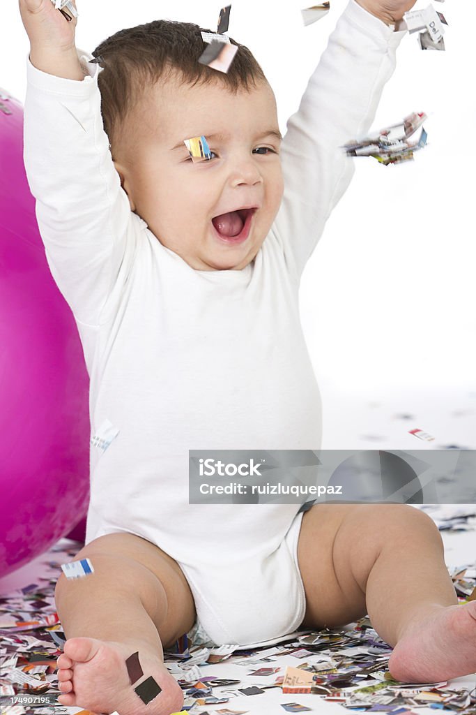 Baby and confetti Having fun with falling confetti Ecstatic Stock Photo