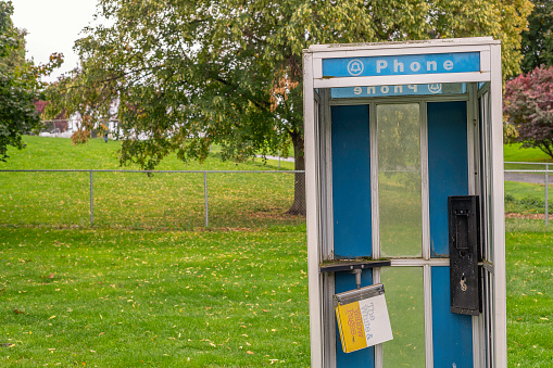 Walla Walla, WA, USA  October 10, 2023: An old public telephone booth stands abandoned in Walla Walla, WA.