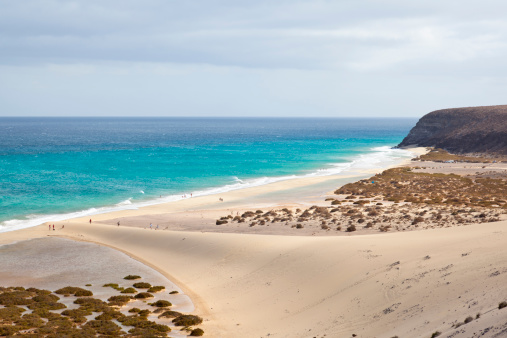 Beach and and the famous sand dune at Playas De Sotavento near Risco El Paso.