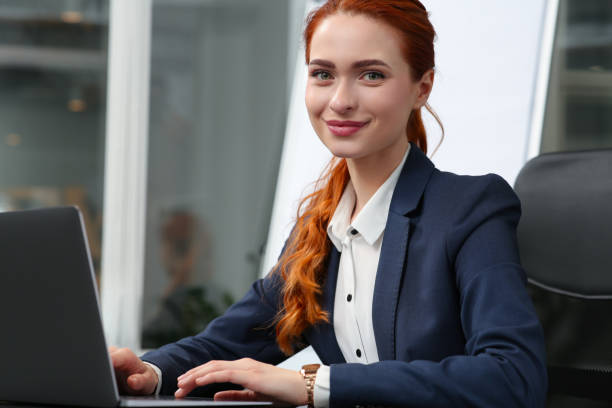 istock Happy woman working with laptop in office 1749079044