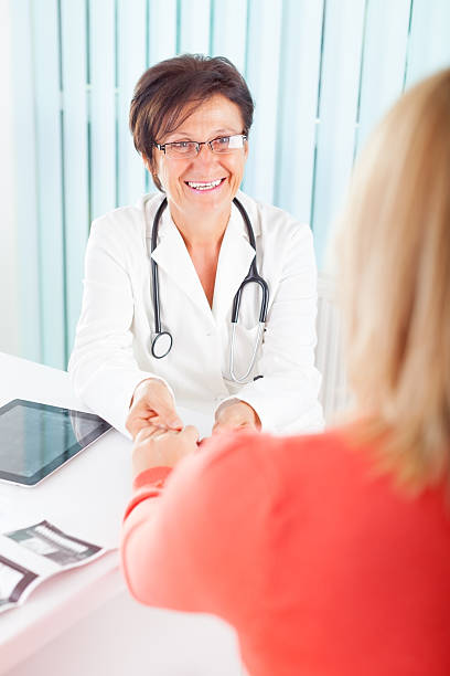 istock Senior female doctor talking with patient 174908060