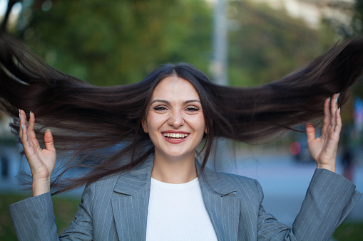 Young woman tossing hair