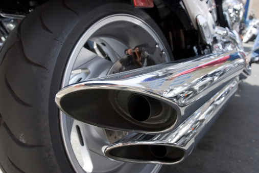 Detail of a motorcycle exhaust shot from low vantage point