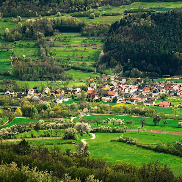 Franconian Village in Spring Elevated view on Franconian village and spring landscape with blooming trees around the Staffelberg. bad staffelstein stock pictures, royalty-free photos & images