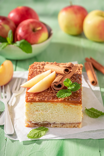 Tasty cheesecake flavored with cinnamon and caramel. Caramel cheesecake with apples.