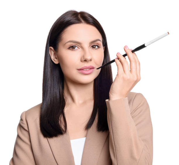 istock Woman using long cigarette holder for smoking isolated on white 1749088500