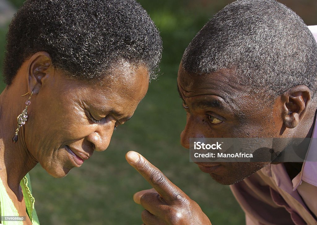 Aggressive Male three "An african man shouts at his wife, pointing his finger in accusation." Mature Men Stock Photo