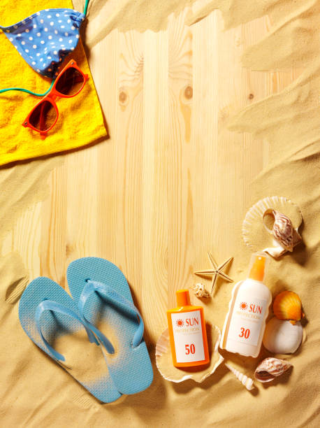 Sand Background of Flip Flops, Sun Cream and Seashells
