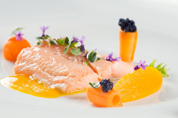 Delicious boiled salmon Boiled salmon with herbs and served with carrot puree. Shallow dof. bull trout stock pictures, royalty-free photos & images