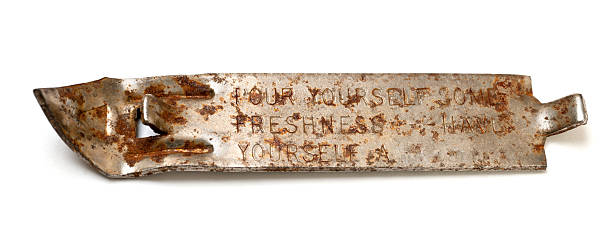 Rusty antique beer can opener isolated on white.RELATED IMAGES: