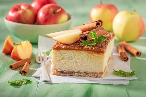 Sweet cheesecake decorated with cinnamon and apples. Apple cheesecake.