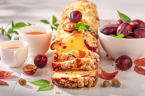 Tasty plum yeast cake made of autumn fruits. Plum yeast cake with crumble and berries.