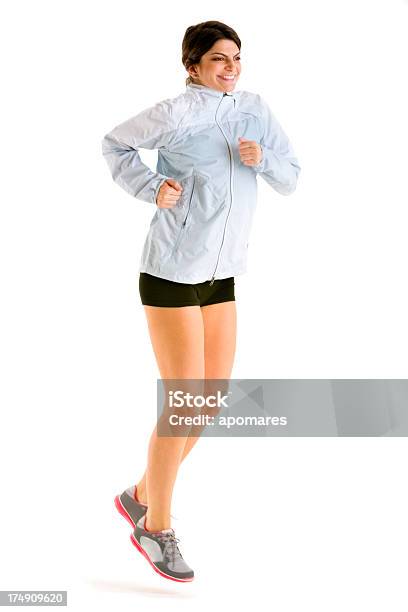 Young Happy Woman Jogging In Studio On White Background Stock Photo - Download Image Now