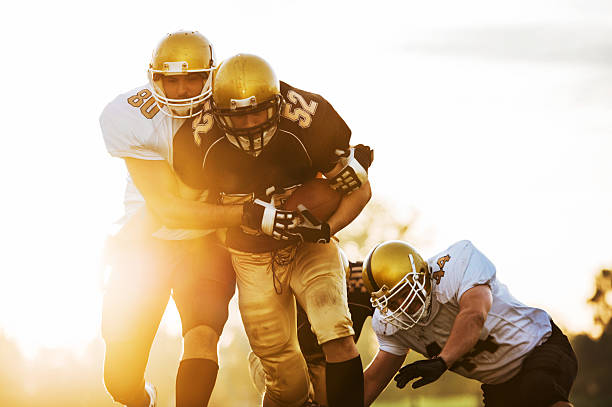 istock College Football - Catch and Tackle. 174909863