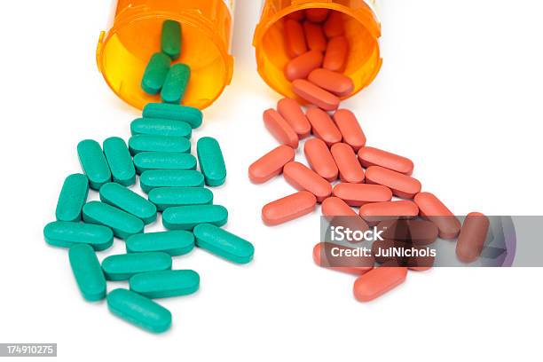 Prescription Medicine Spilling From Pill Bottles Stock Photo - Download Image Now - Comparison, Medicine, Orange Color