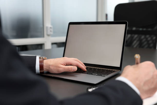 istock Man writing notes while working on laptop at black desk in office, closeup 1749103361