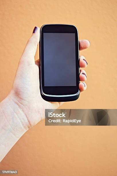 Female Hand Holding Up Smart Phone Screen Providing Copy Space Stock Photo - Download Image Now
