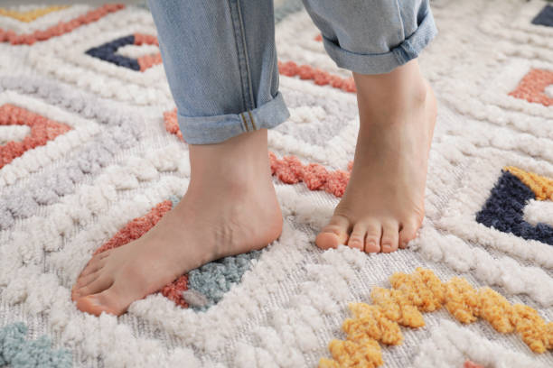 istock Woman standing on soft carpet at home, closeup 1749117579