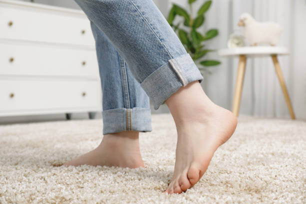 istock Woman standing on soft carpet at home, closeup 1749117586