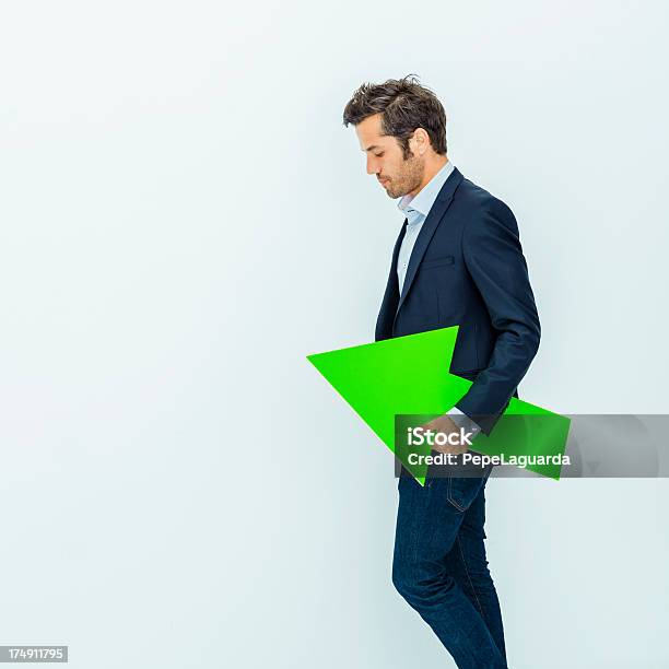 Businessman Holding A Green Arrow Stock Photo - Download Image Now - Arrow Symbol, One Person, People