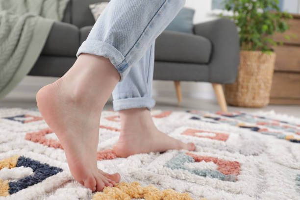 istock Woman standing on soft carpet at home, closeup 1749118648