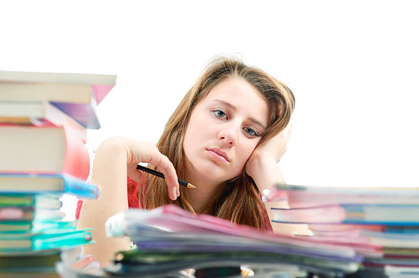 молодая девушка недовольна домашняя работа - schoolgirl boredom frustration adult student стоковые фото и изображения