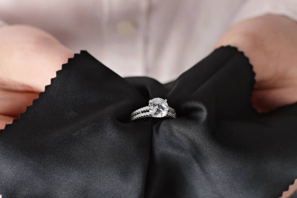 istock Jeweler cleaning diamond ring with microfiber cloth, closeup 1749119423