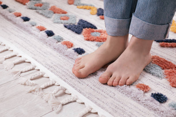 istock Woman standing on carpet with pattern at home, closeup 1749119706