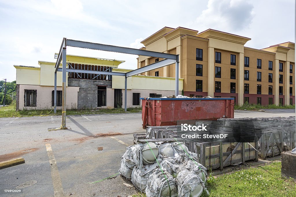 Hotel construction stopped before complete Hotel remodel halted before completion due to finance problems. Crates of uninstalled sinks and marble countertops rot in the foreground waiting on funding to complete the project. Abandoned Stock Photo