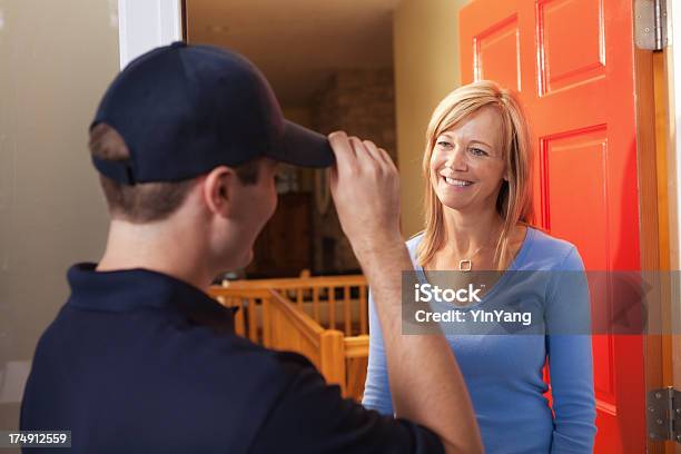 Service Or Home Delivery Man Greeting Woman Customer At Door Stock Photo - Download Image Now