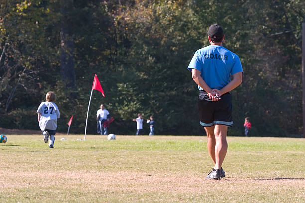 istock coach watching kids soccer game 174912780