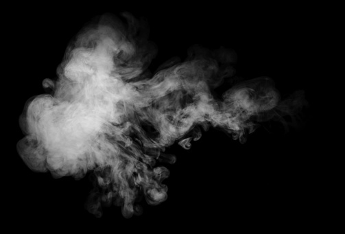 A puff of smoke or steam photographed against a black background.