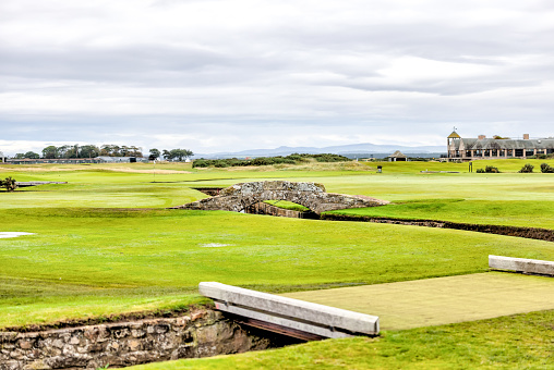 St. Andrews, Scotland, United Kingdom - April 28, 2022: View of the Royal and Ancient Gold Club of St Andrews clubhouse, near the first tee at the Old Course, with guests. St Andrews is the oldest golf course in existence.