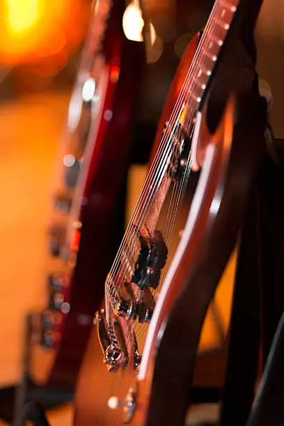 "Two e-guitars on stage , shallow depth of field"