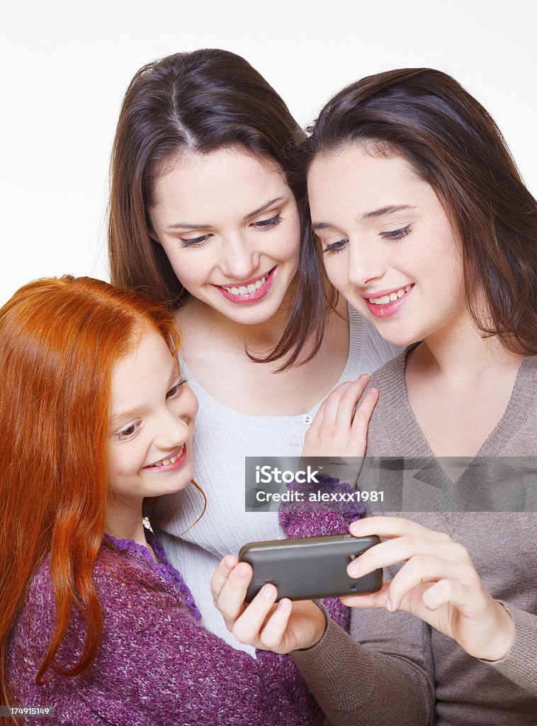 Teen Meninas de mensagens de texto em simultâneo - Royalty-free Adolescente Foto de stock