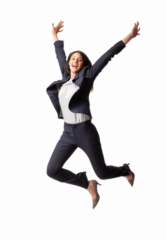 Full length of an exhilarated young businesswoman jumping in mid-air. Vertical shot. Isolated on white.