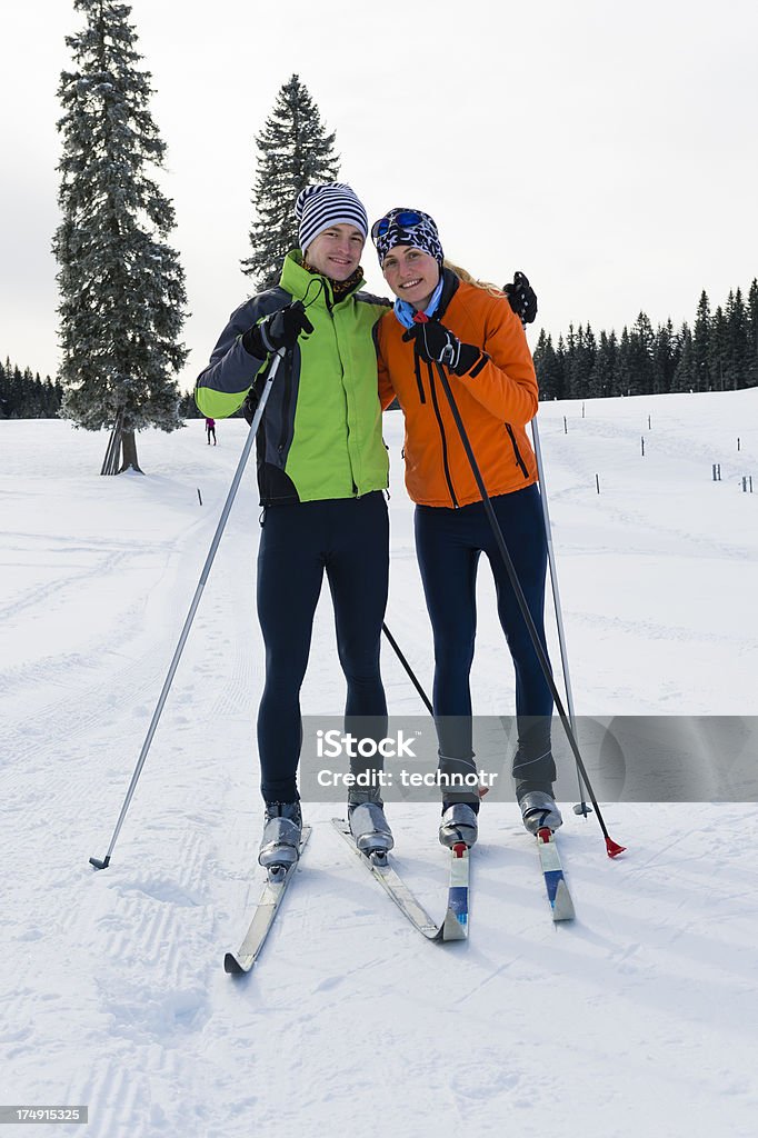 Молодая пара, которые позируют после лыжах - Стоковые фото Лыжные гонки роялти-фри