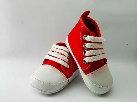 Little boy's red shoes on a white background