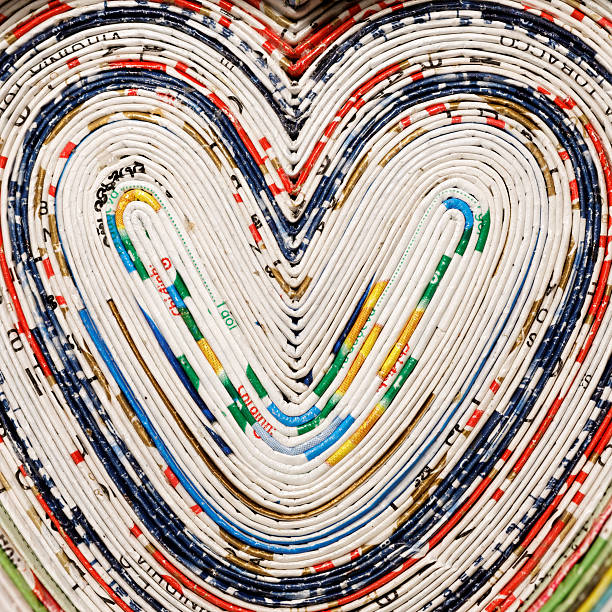 hearts heartshape of recycled rolled newspaper pages, detail abstract newspaper macro heart shape stock pictures, royalty-free photos & images