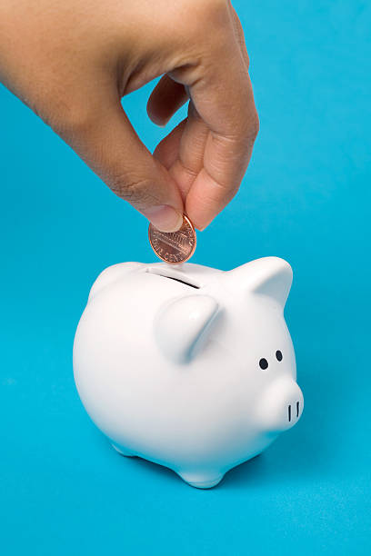 Filling the Piggy Bank stock photo