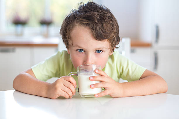 istock portrait of small boy drinking milk 174916292