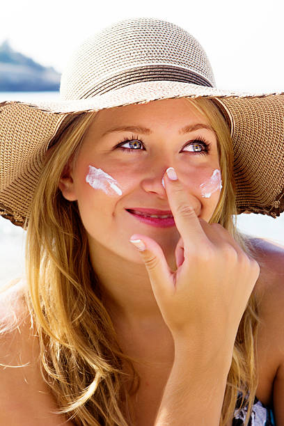 istock Pretty young woman with suntan lotion 174916406