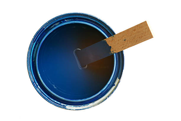 Medium sized opened can with blue paint and wooden stirrer