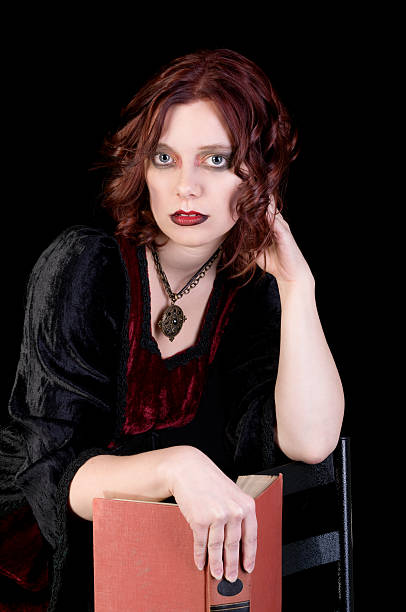istock Beautiful vampiress holding book. 174917106